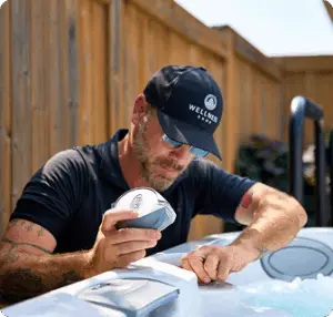 Technician repairing a hot tub component.