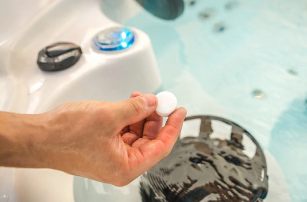 man adding chloring puck to spa to combat hot tub bacteria